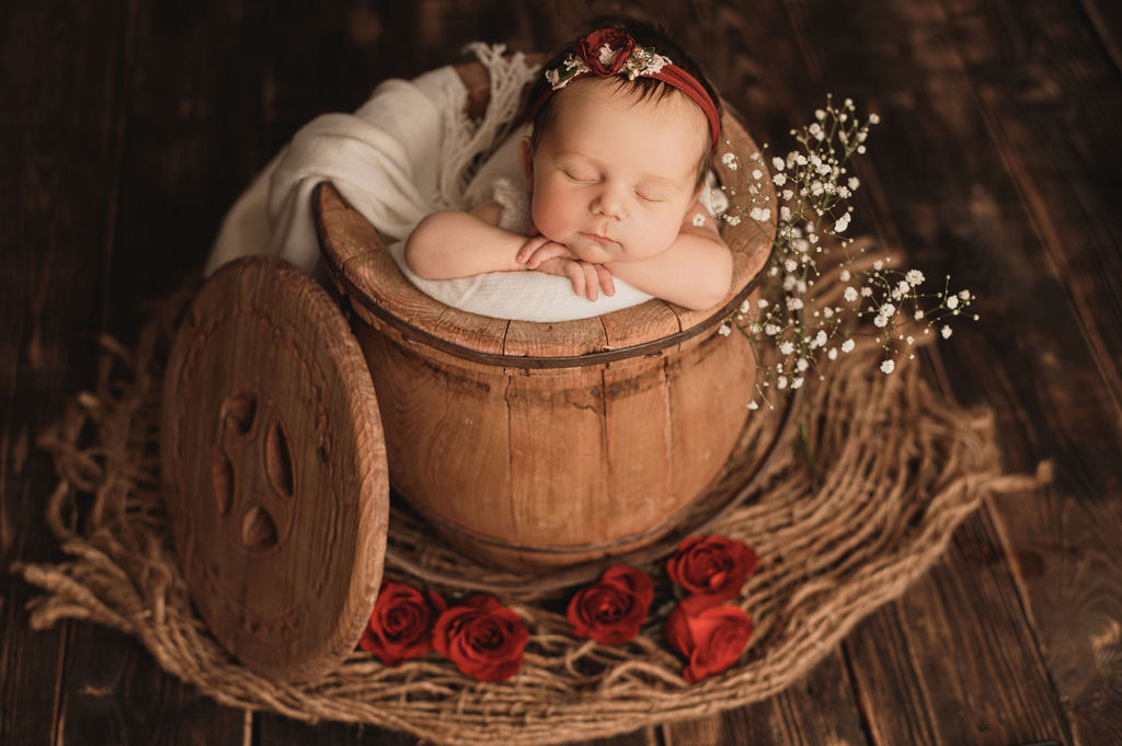 newborn baby in a bucket sleeping Pediatric Dentist Burlington